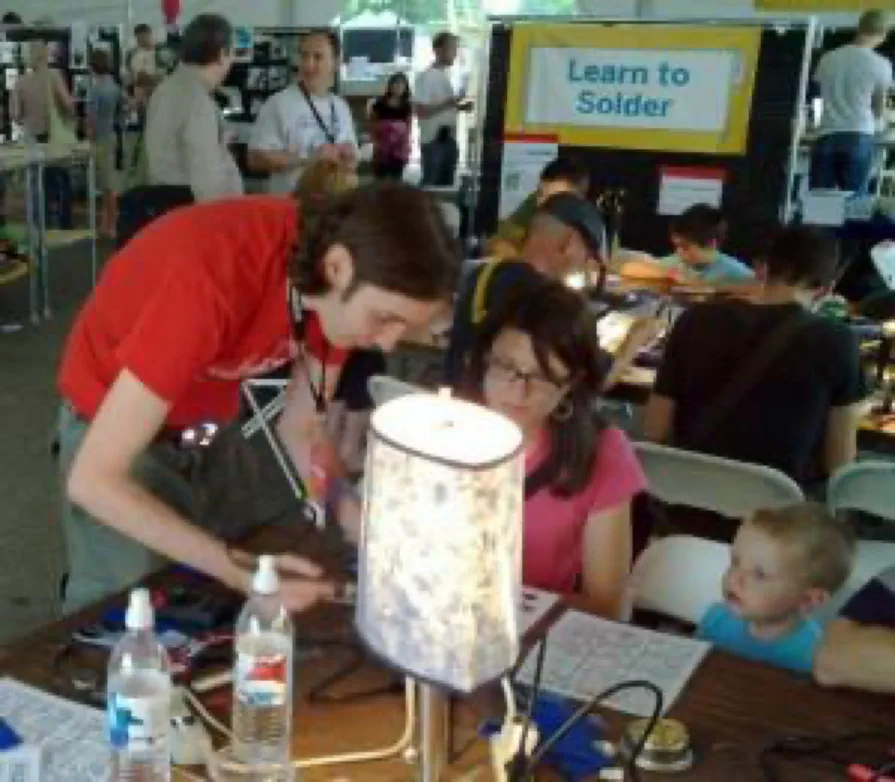 Soldering tables under a banner reading “Learn to Solder” Soldering tables under a banner reading “Learn to Solder”